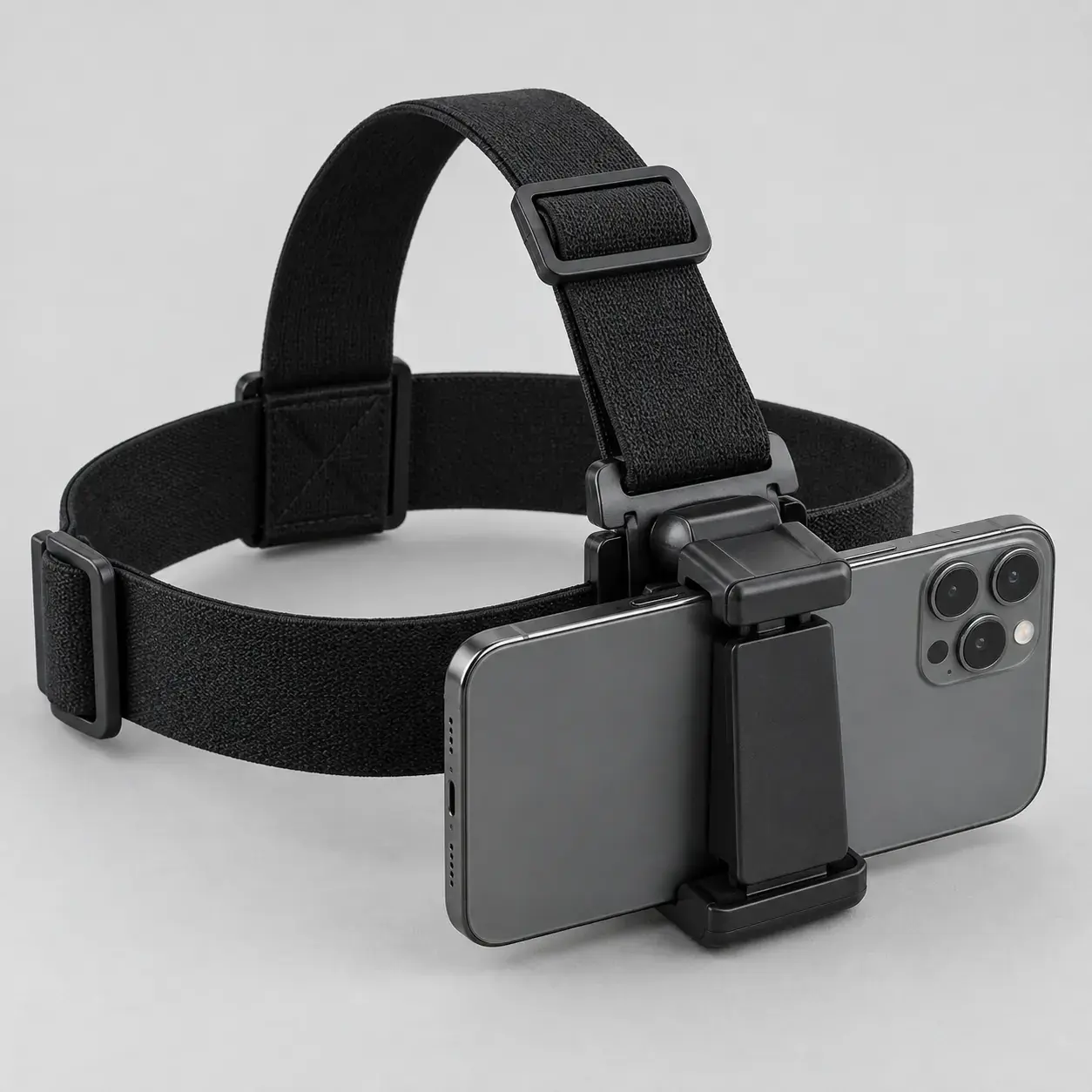A black elastic head strap with a phone clamped to the front, cameras facing out.
